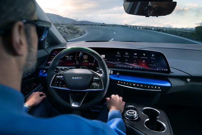 Front View of the 2026 OPTIQ-V Driving Through the Dusk Utilizing its Headlights | Faulkner Cadillac Bethlehem in Bethlehem PA